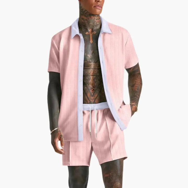  Model showcasing a men’s button-up summer set with matching shorts on a plain background.
