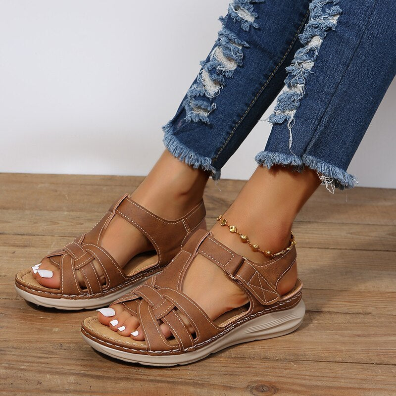 Front close-up sandals on plain background with foot model