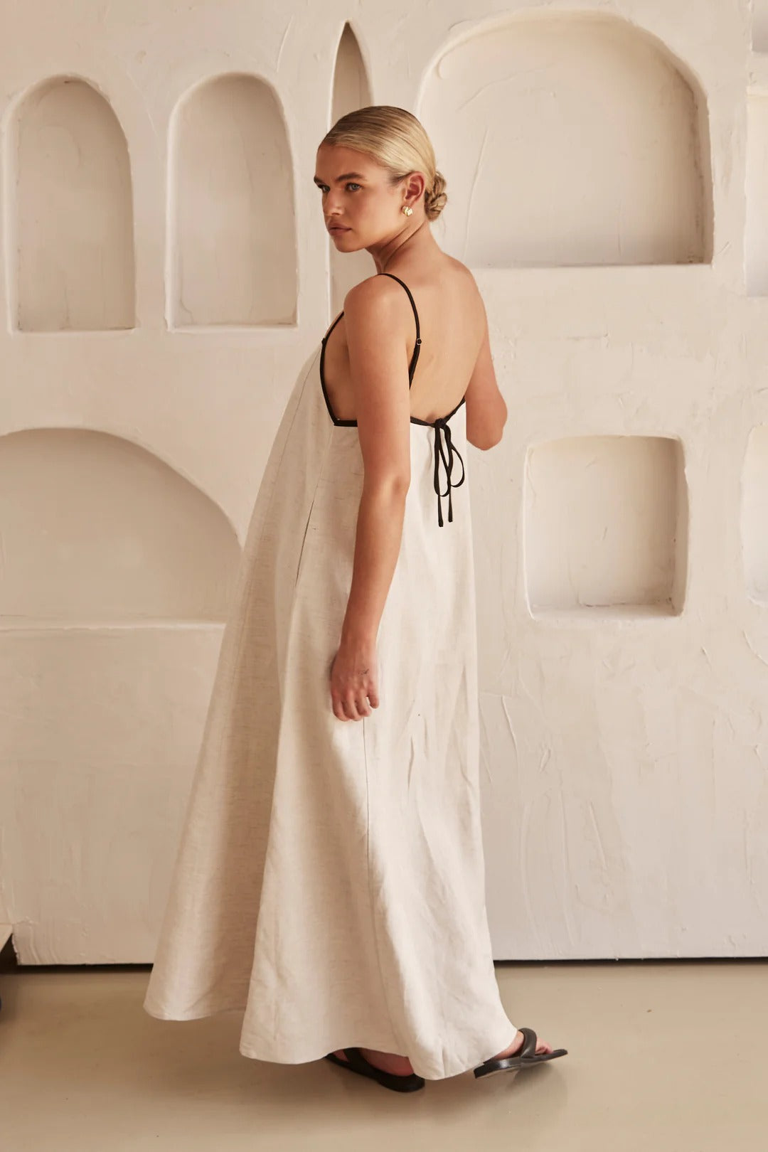 Woman wearing long summer dress relaxed pose background image
