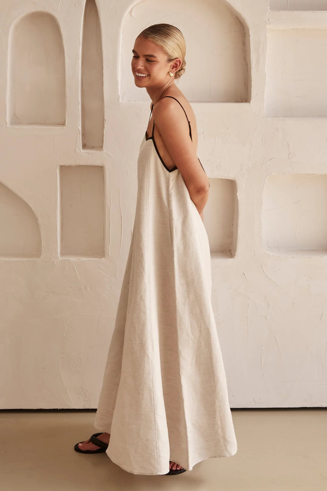 Woman relaxed stance soft flowing dress studio plain background image