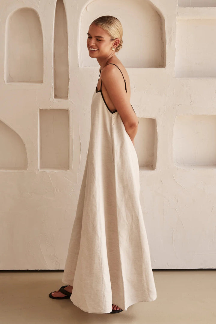 Woman relaxed stance soft flowing dress studio plain background image