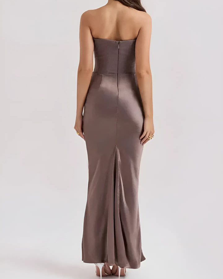 Model back view of elegant maxi dress smooth drape plain background
