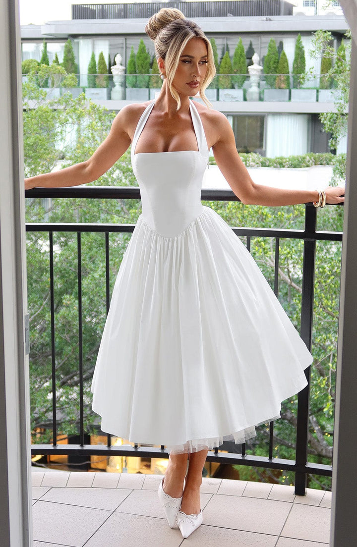 Female model posing front view in flowing midi dress