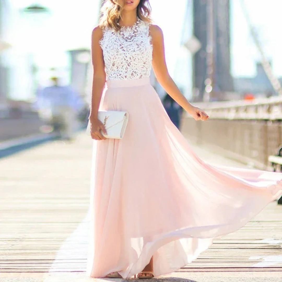 Female model wearing embellished maxi dress on blurry bridge background