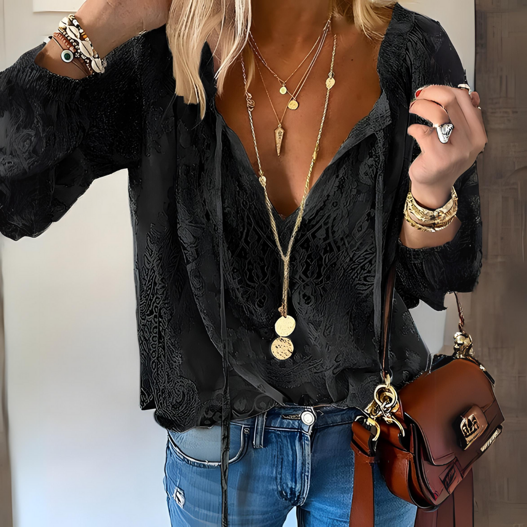 Woman showcasing a lightweight summer blouse with decorative detailing.