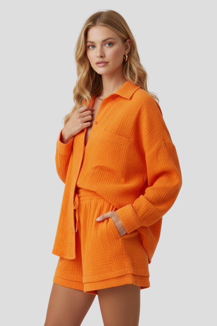 Female model posing side view in relaxed summer outfit, gray background.
