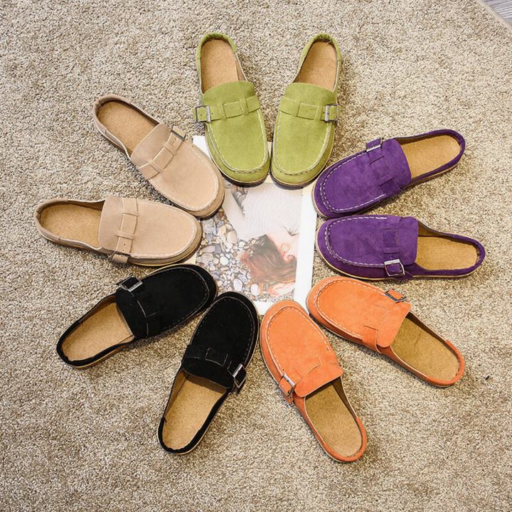 Colorful loafers arranged in a circular pattern on a textured surface.