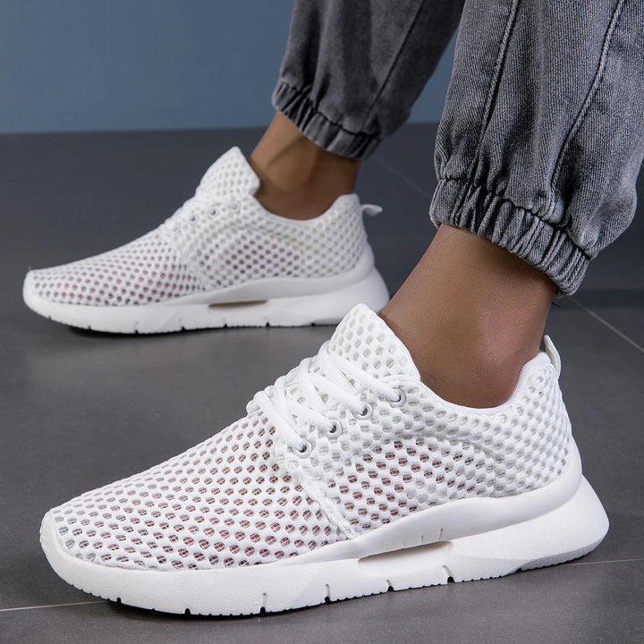 Stylish mesh white casual shoes worn with gray joggers