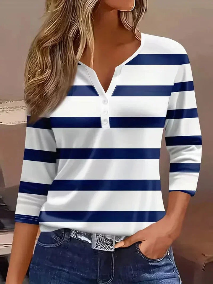 Female model wearing a breathable striped blouse on a plain background.