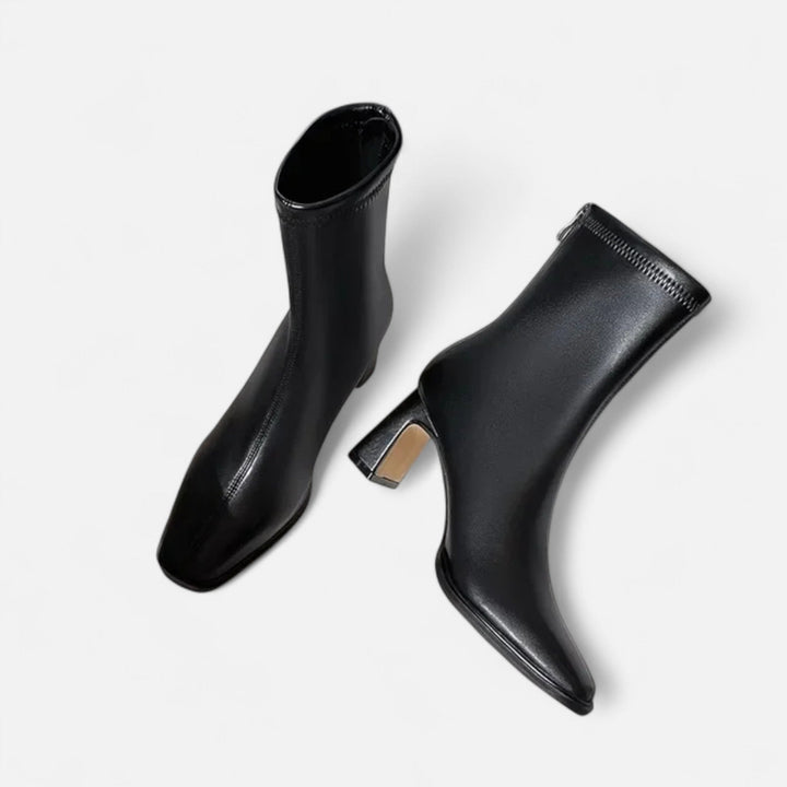 Block heel ankle boots for smart styling on a plain background.