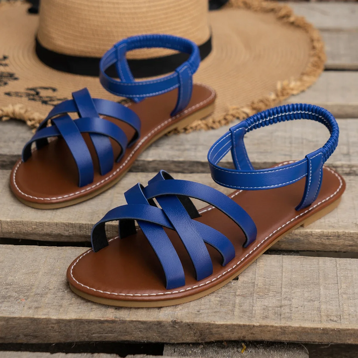 Fashion shot sandals on foot beige background studio