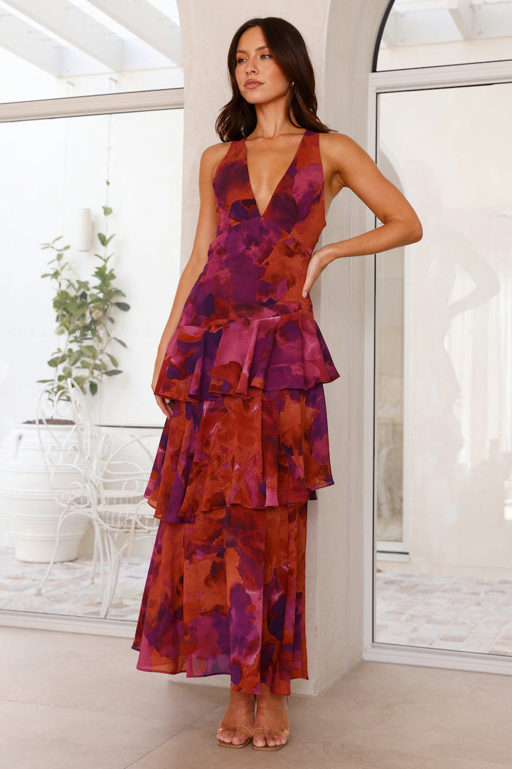 Slight angle pose floral layered dress on model plain background