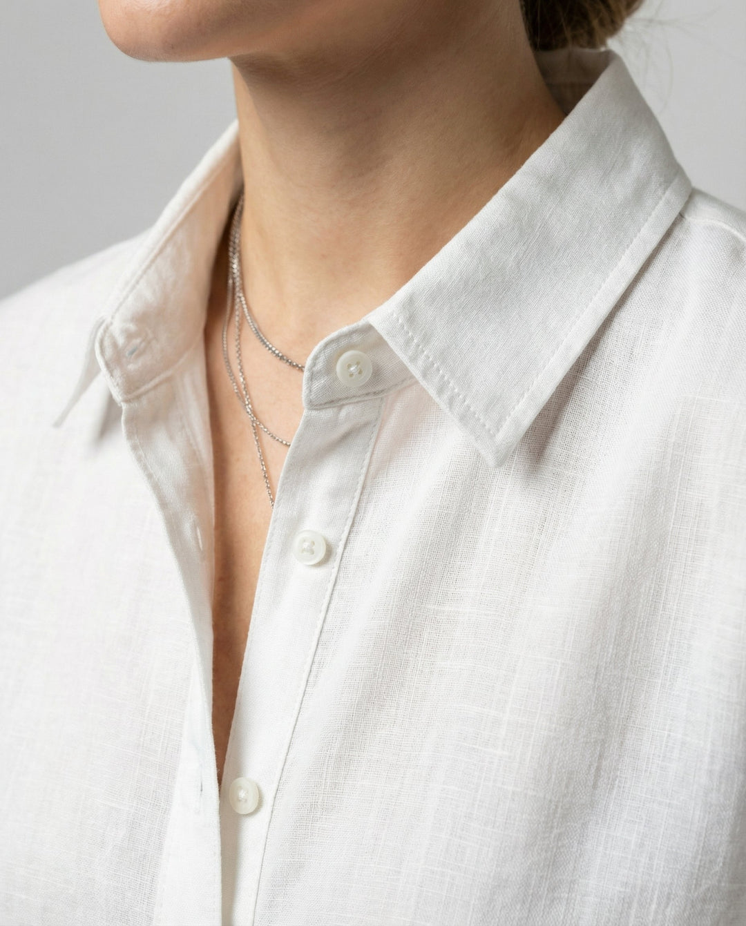 Woman wearing a smart casual blouse suitable for office and everyday wear.
