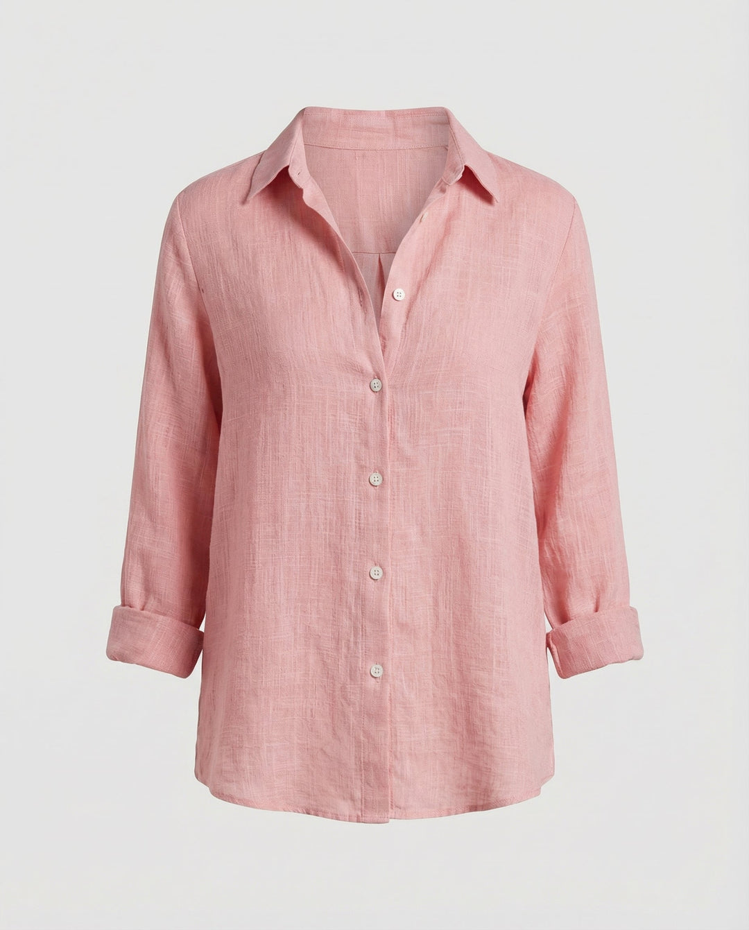 Woman in a comfortable blouse styled with a classic V-neckline against a plain backdrop