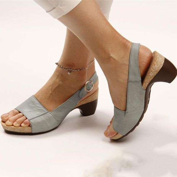 Foot model wearing slingback heels on white background