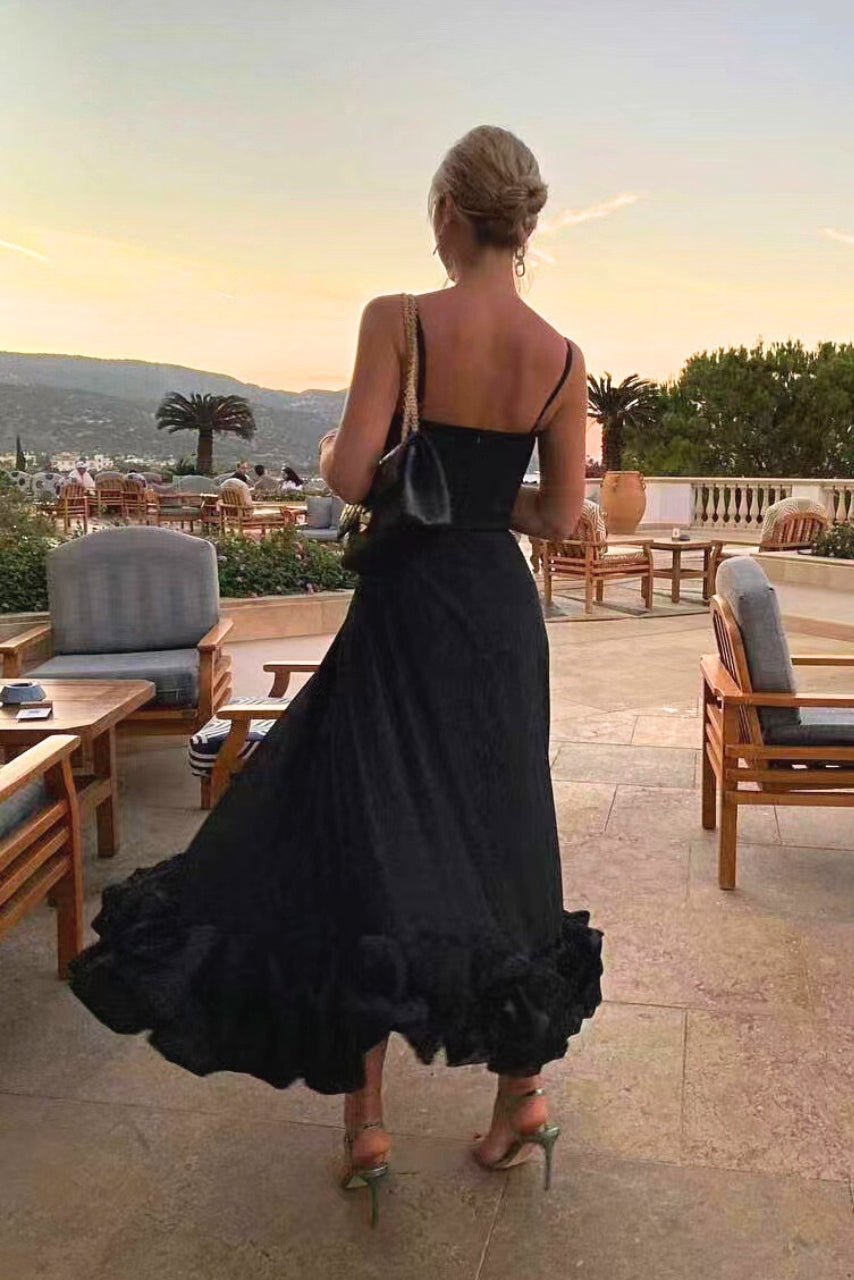 Back angle on sleeveless black party dress on outdoor balcony