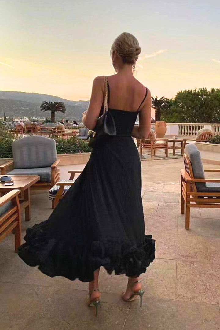 Back angle on sleeveless black party dress on outdoor balcony