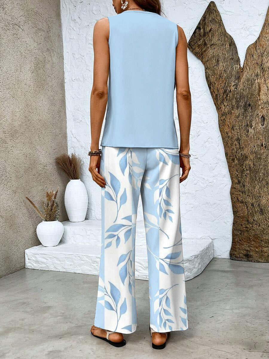  Woman wearing a fashionable layered top and relaxed-fit pants on a plain background.