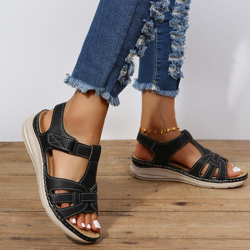 Top view breathable sandals on plain background foot model