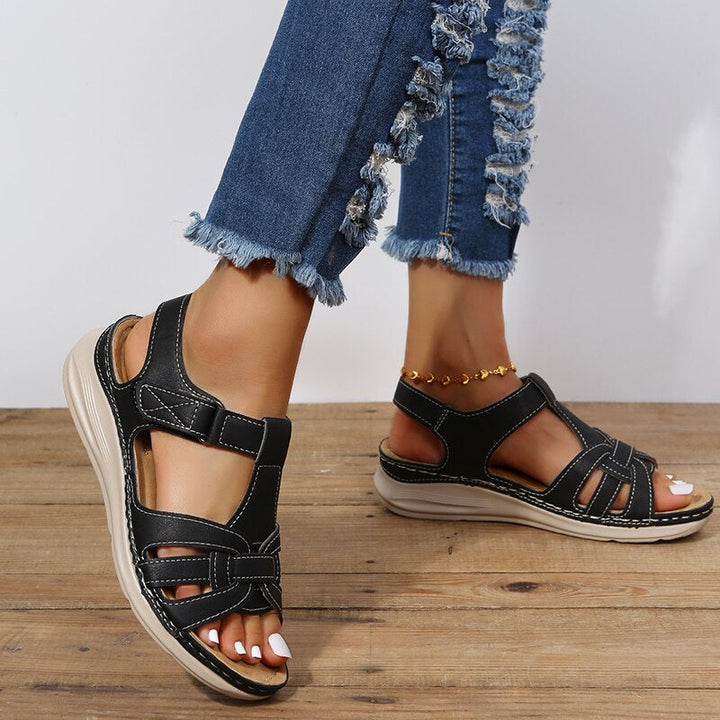 Top view breathable sandals on plain background foot model