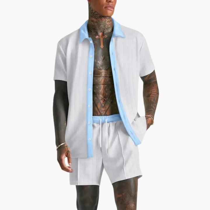 Model wearing a men’s two-piece summer shirt and shorts set on a plain background.