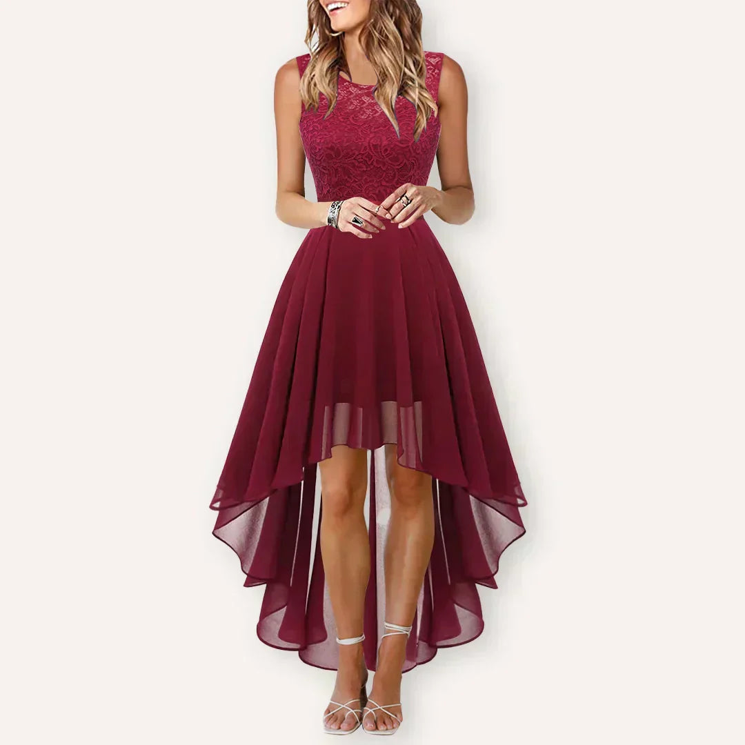 Female model displaying a stylish occasion dress with a clean hemline on a plain background.