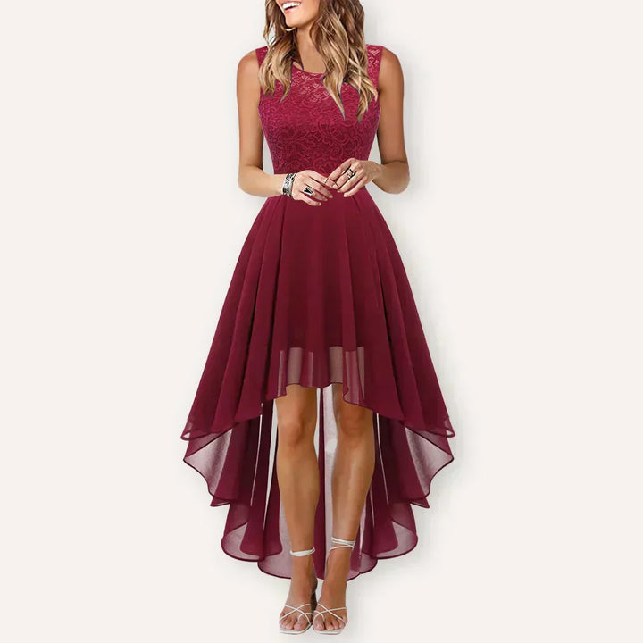  Female model displaying a stylish occasion dress with a clean hemline on a plain background.