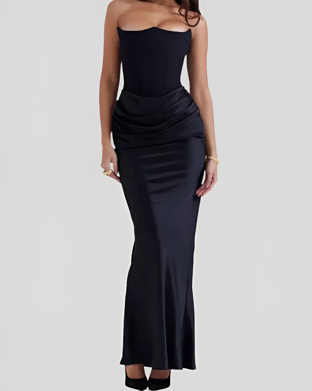 Model walking pose showing movement of long dress plain background