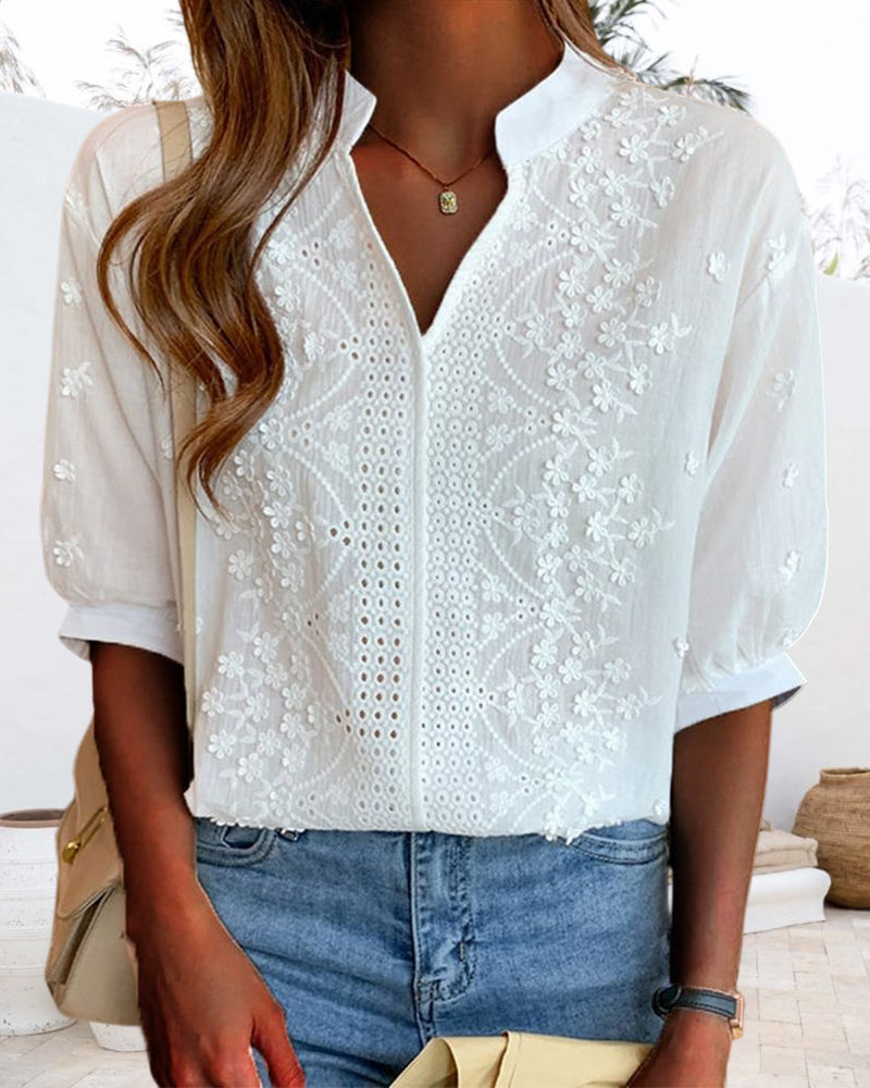 Elegant summer blouse with soft sleeves displayed on a clean background.