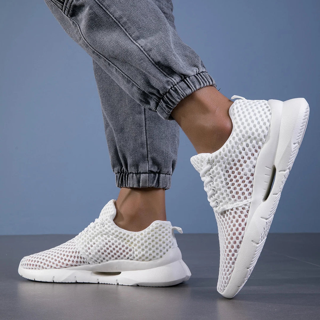 Side profile of white mesh walking shoes
