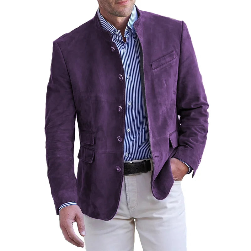 Male model displaying a contemporary tailored jacket with front pockets on a plain background.