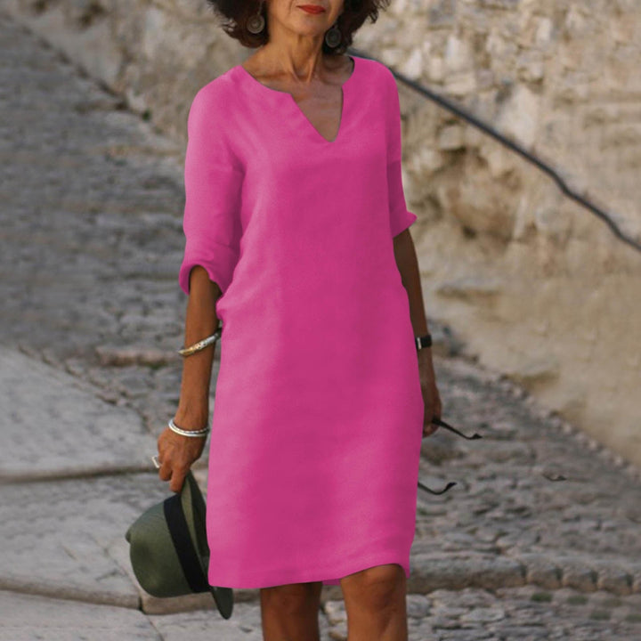 Woman model wearing a simple casual midi dress with comfortable coverage.