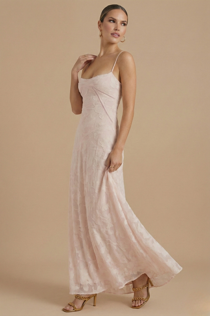  Model wearing a sleeveless floral dress with a floor-length skirt on a plain background.