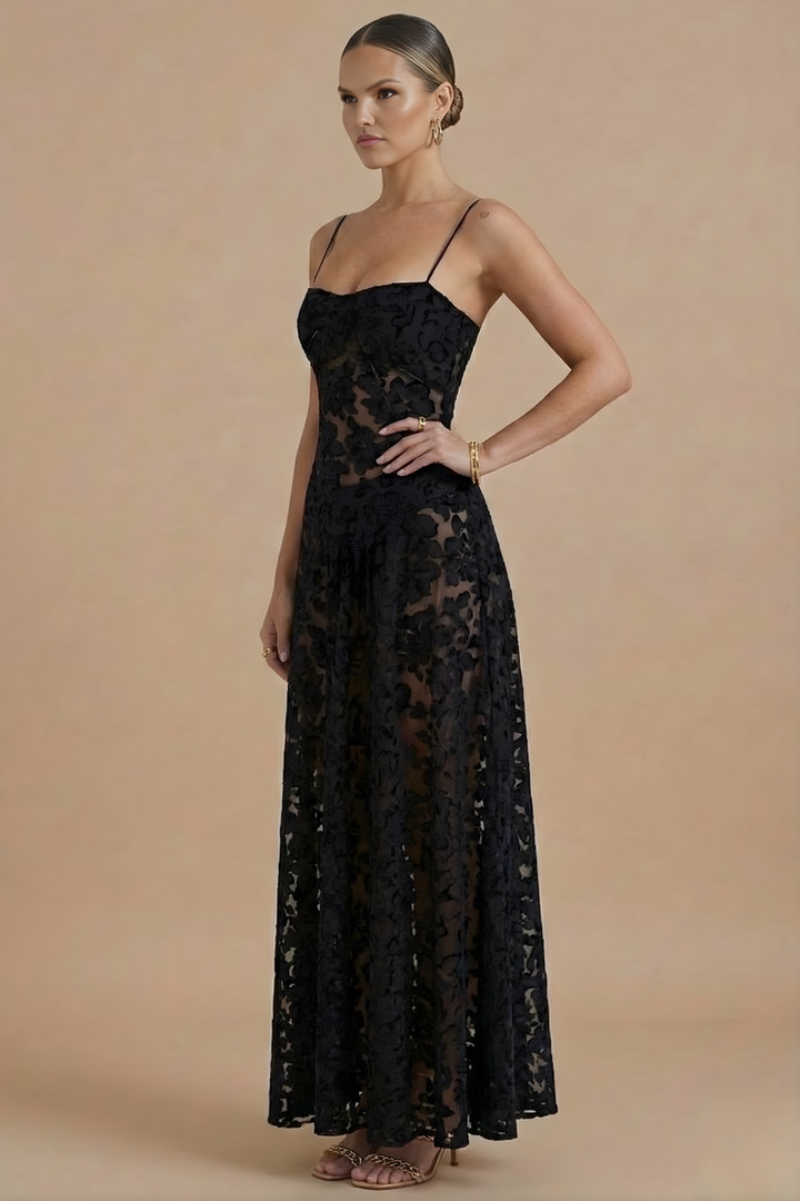  Woman wearing a graceful floral maxi dress with a fitted upper design on a plain background.