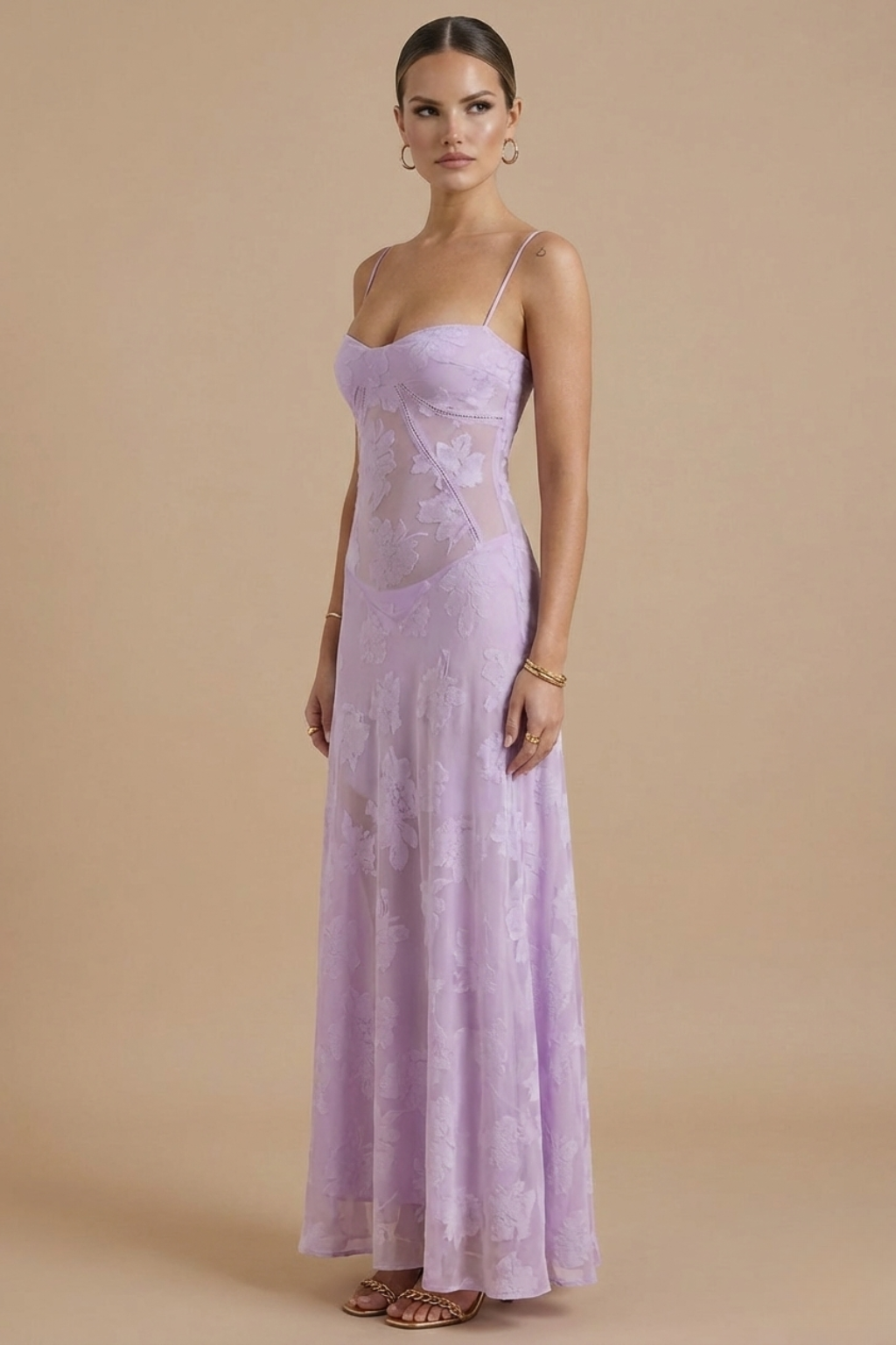  Model in a formal floral maxi dress with soft flowing movement on a plain bac