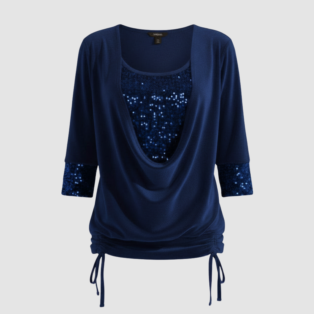 Long sleeve sequin top against a plain background.