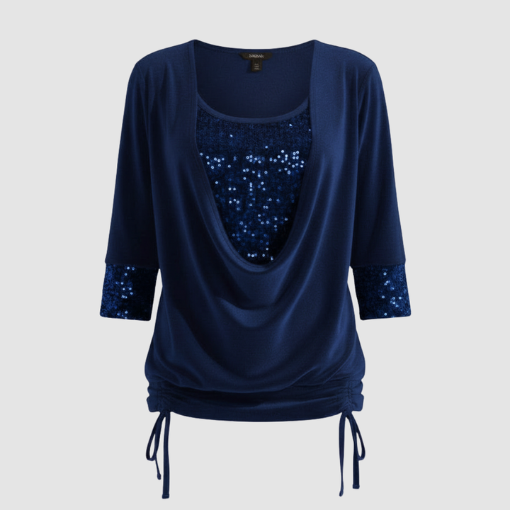 Long sleeve sequin top against a plain background.