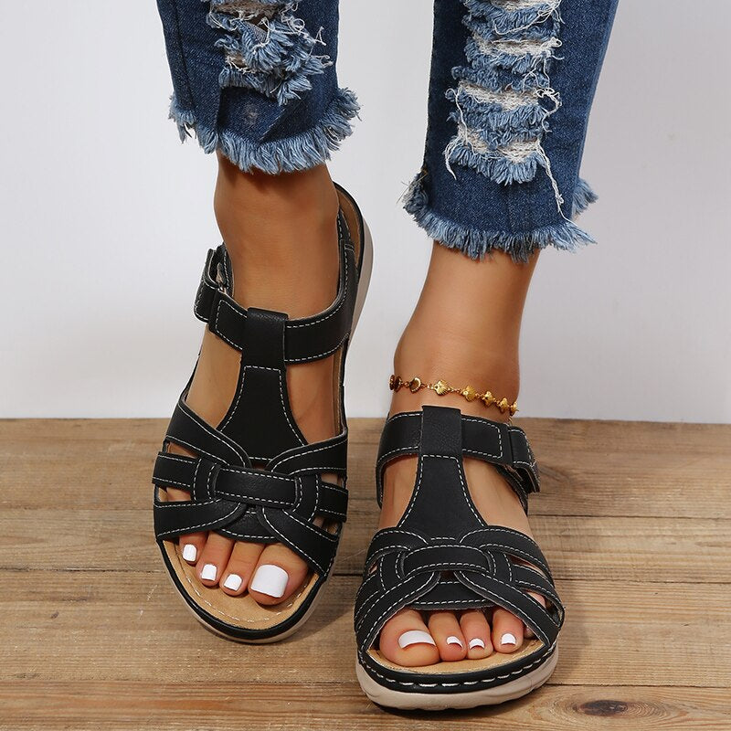 Minimalist sandals pose on plain background featuring foot model