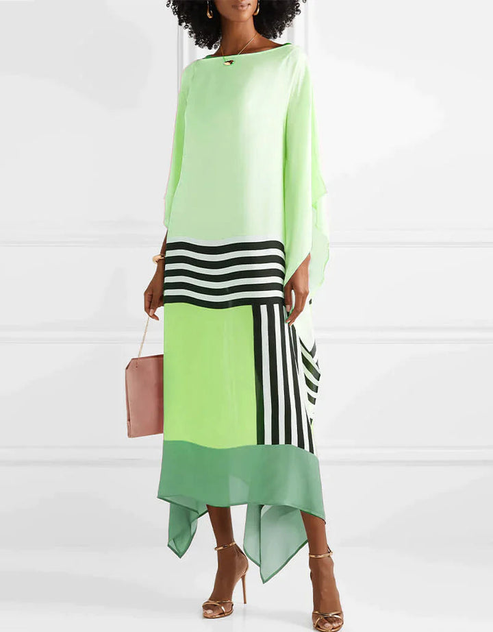 Artistic print kaftan worn by a model in a plain background setting.