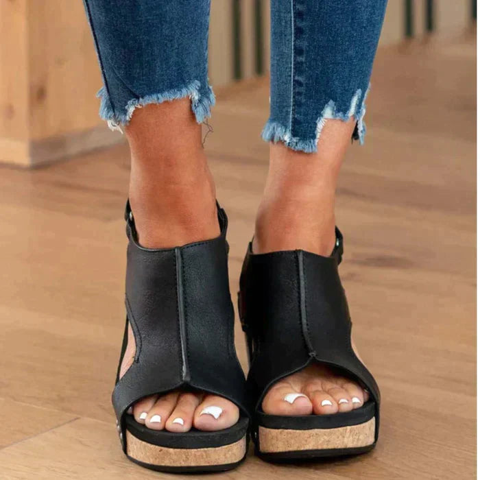 Foot model tilted pose wedge sandals plain background neutral tone