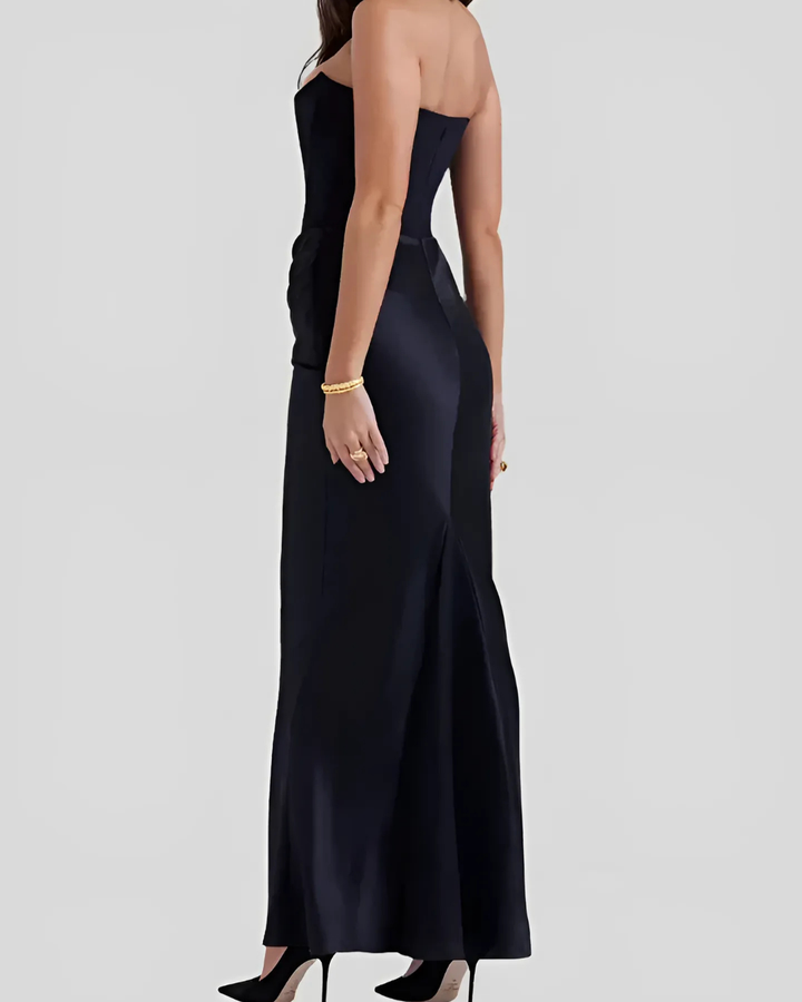 Model slight turn highlighting soft draped lines plain background