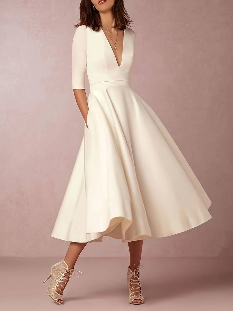 Woman posing with heels flared midi outfit plain background