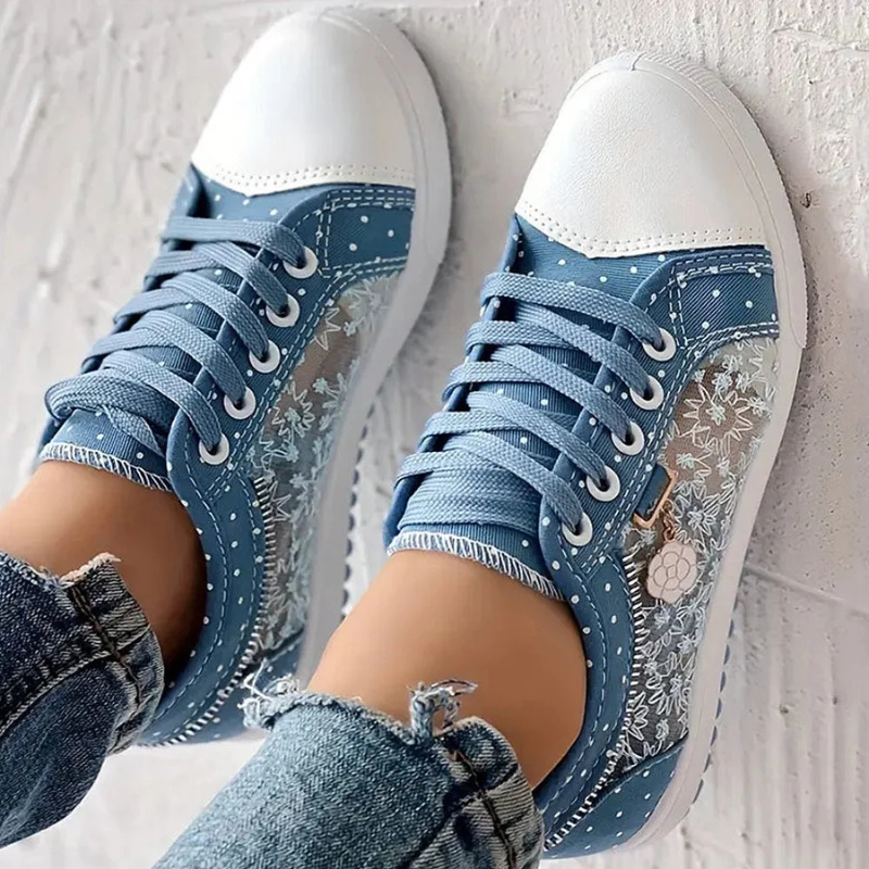 Close view of blue shoes with floral overlay