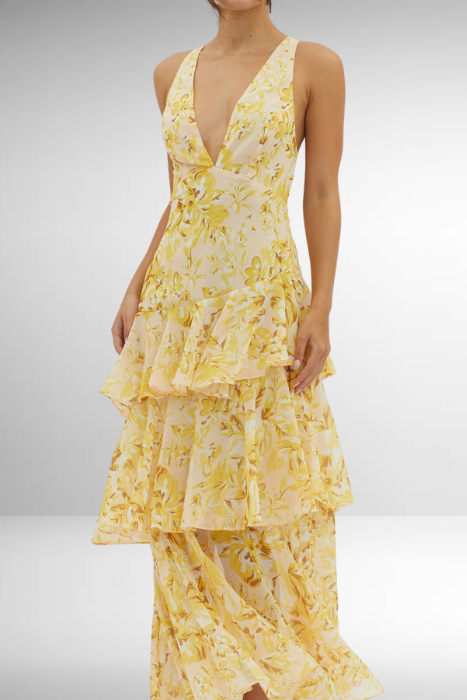 Model looking forward wearing floral dress plain background
