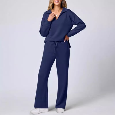 Female model in a relaxed long sleeve top and leggings on a plain background.