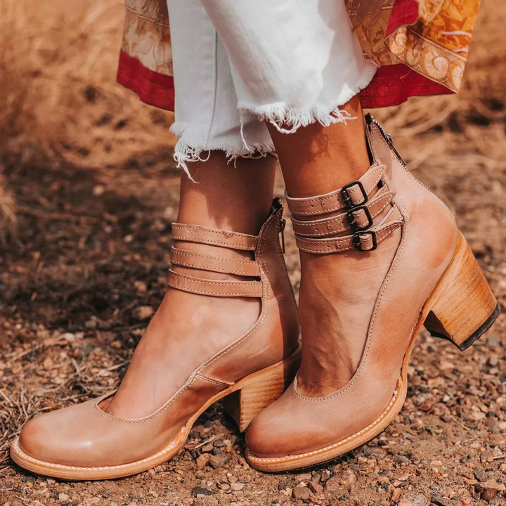  Woman highlighting fashionable sandals in a clean plain background image.
