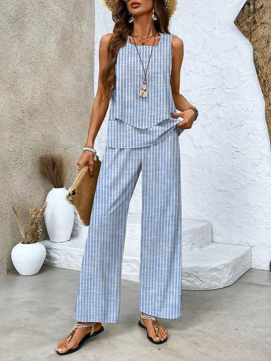  Female standing in a stylish matching outfit featuring a sleeveless top and wide-leg pants.