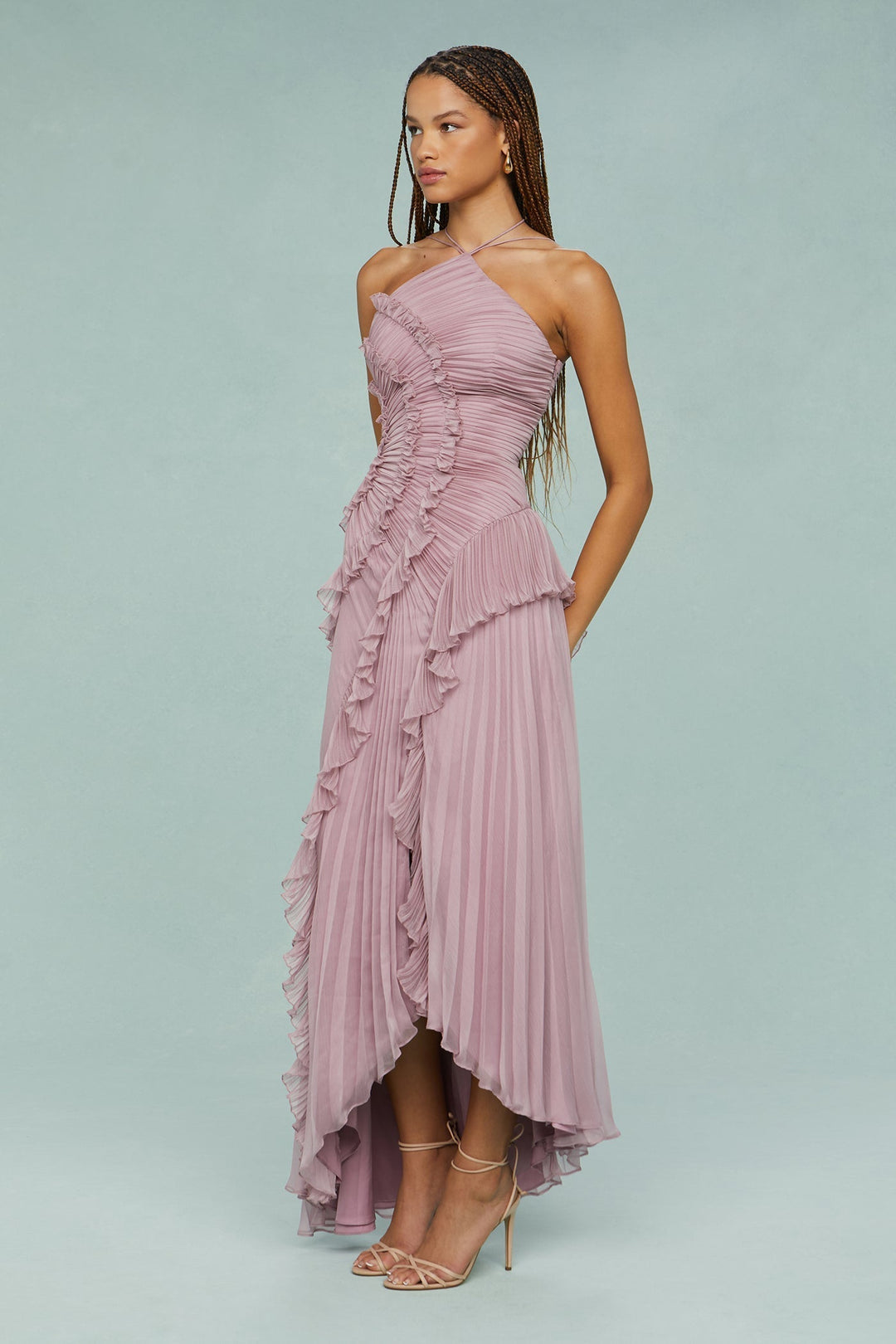 Female model showcasing a dressy celebration look against a plain background.