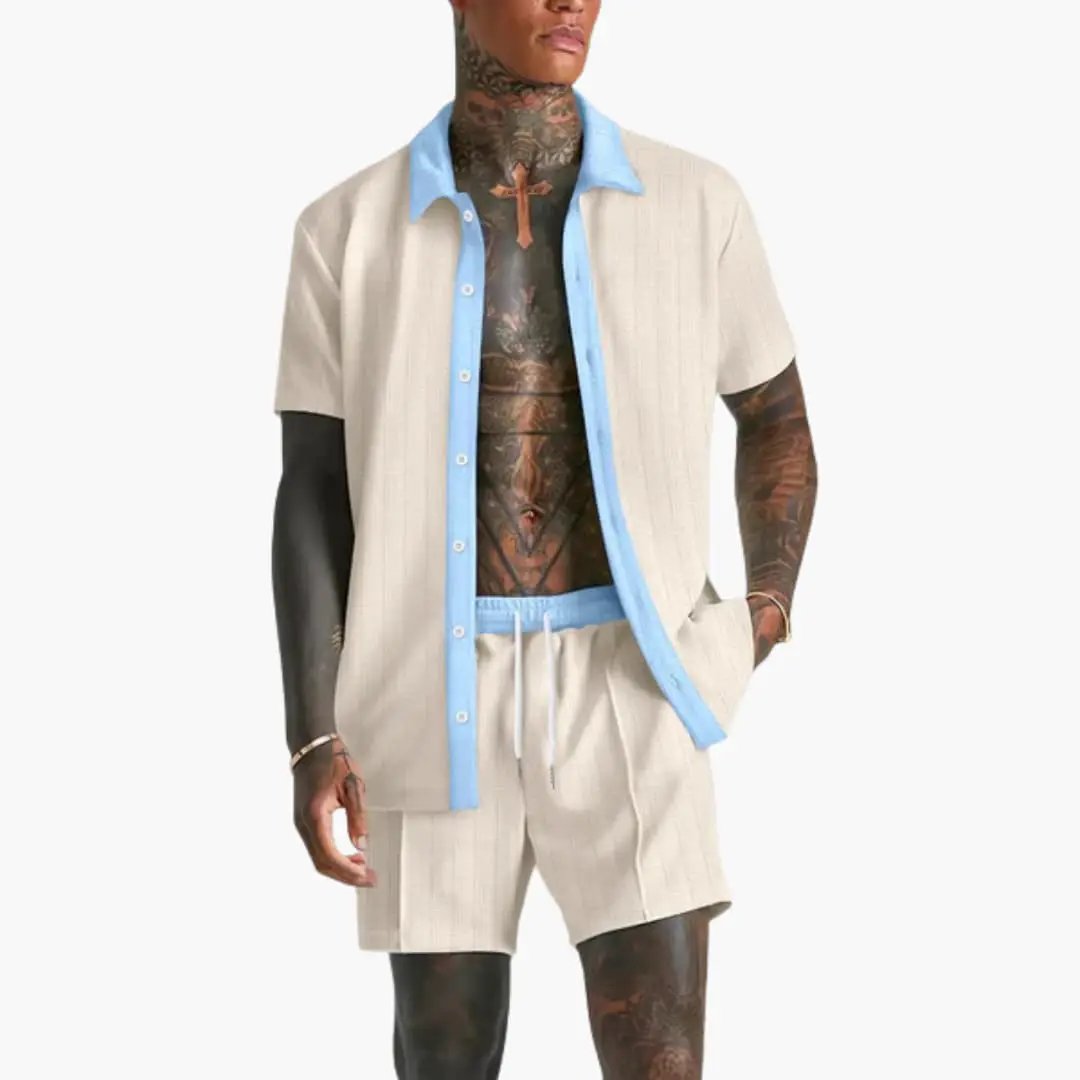  Model wearing a relaxed men’s vacation outfit with contrast trim on a plain background.