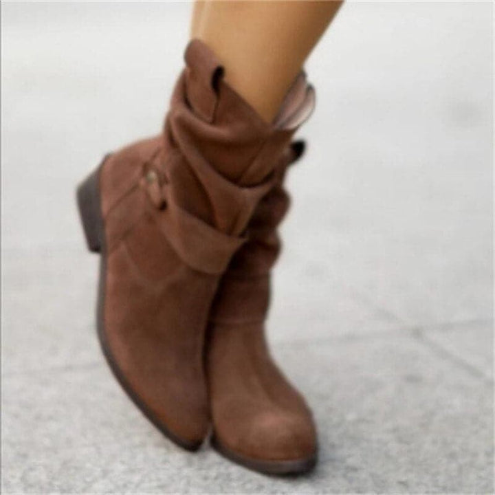 Brown boots on a light gray background